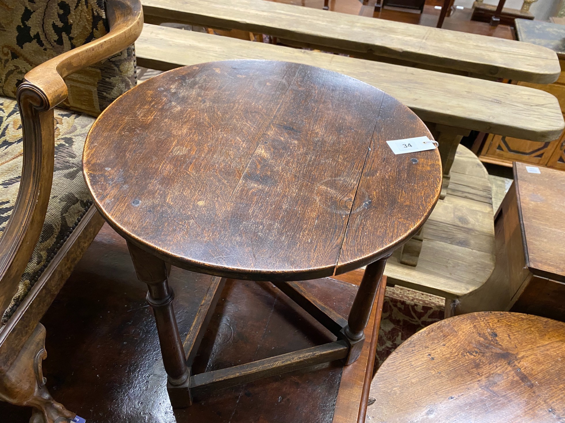 An early 20th century oak cricket table, diameter 55cm, height 61cm